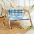 Elevated wooden cat bed with blue cloth hammock in beach chair style