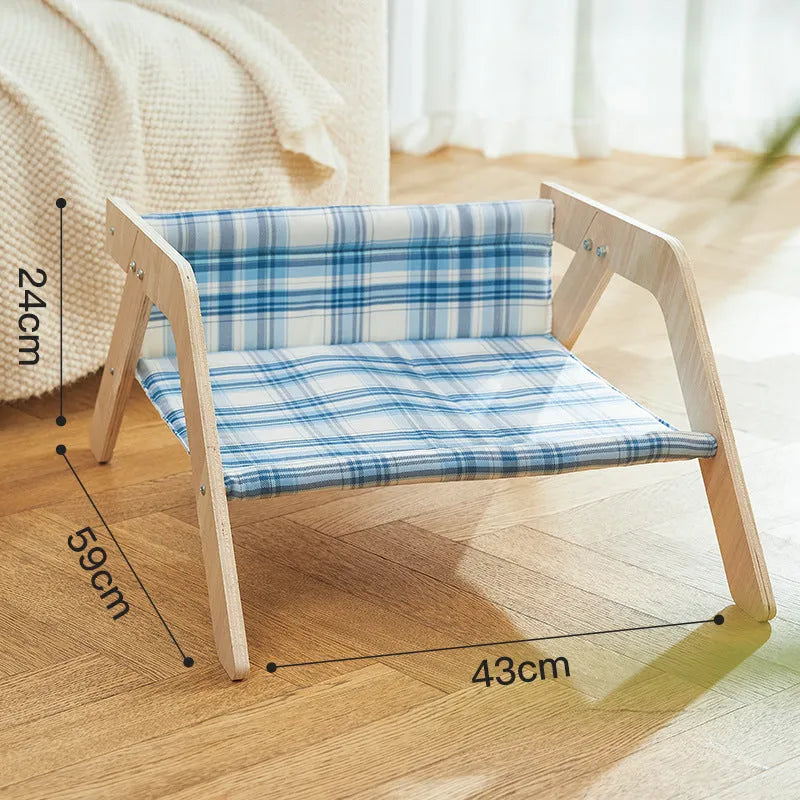 Elevated wooden cat bed with blue cloth hammock in beach chair style
