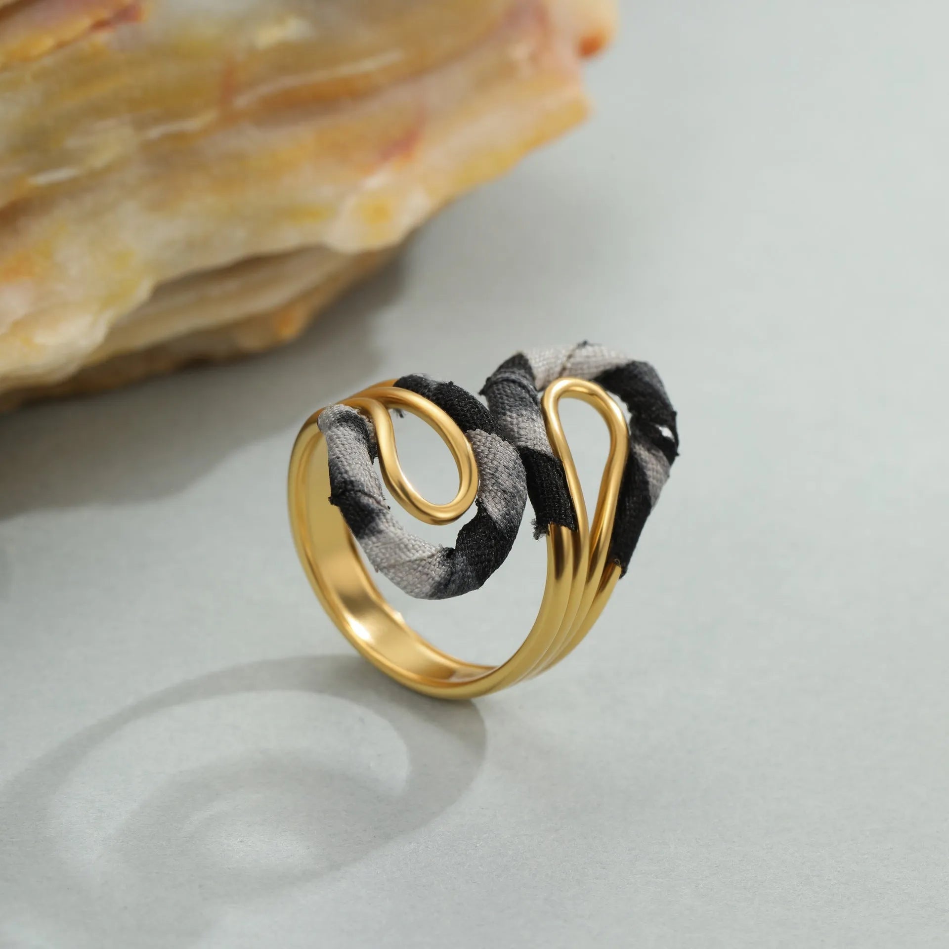 Geometric open mouth ring with leopard print design in electroplated stainless steel showing adjustable free-size construction