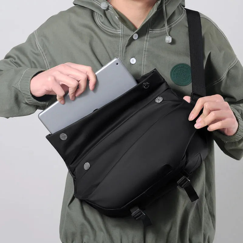 Grey crossbody bag for men showing horizontal square shape, shoulder strap, and zipper opening