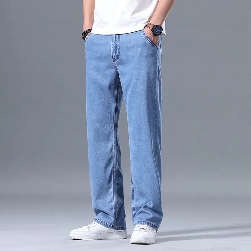 Men's light blue loose straight-leg lyocell jeans with a zipper fly, laid flat.