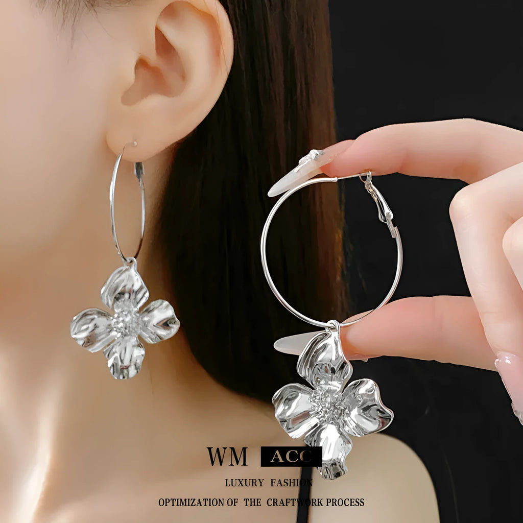 Gold and silver metal earrings with floral geometric design and electroplated finish