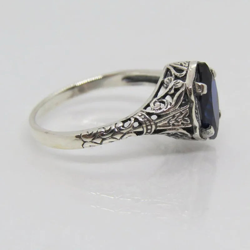 Silver women's geometric hollow alloy ring showing detailed openwork design.