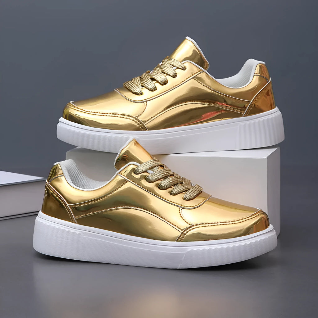 Gold sequinned platform sneakers with thick sole and round toe on a white background.