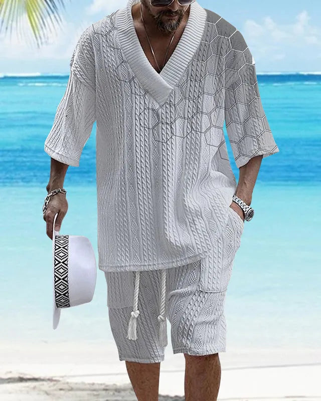 Man wearing a printed drop-shoulder knitted short-sleeve top and matching shorts in a casual setting.