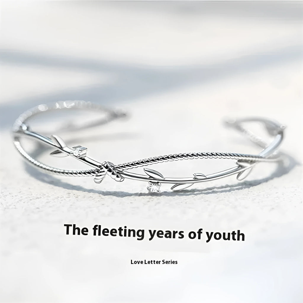 Twisted branch sprout bracelet in white gold finish with detailed copper construction