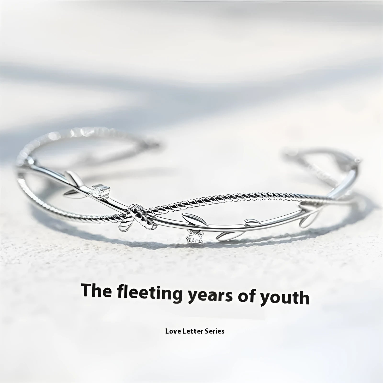 Twisted branch sprout bracelet in white gold finish with detailed copper construction