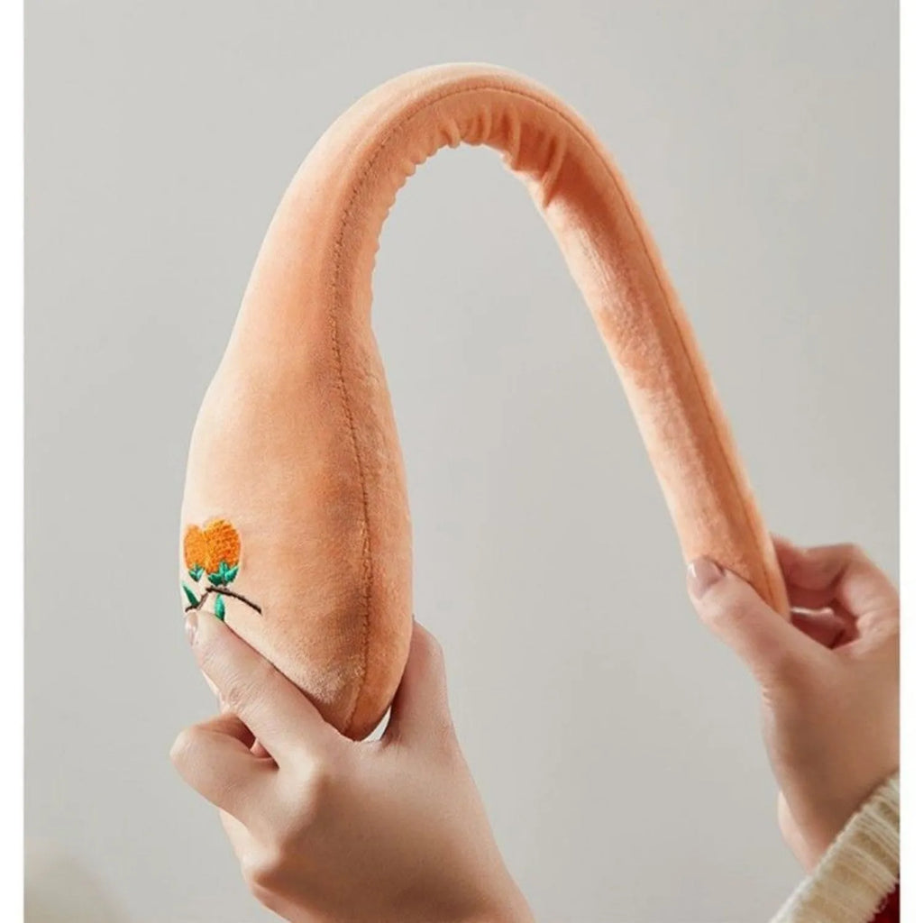 48 cm long persimmon coloured back pounding stick with a meridian flap and zipper for percussion massage