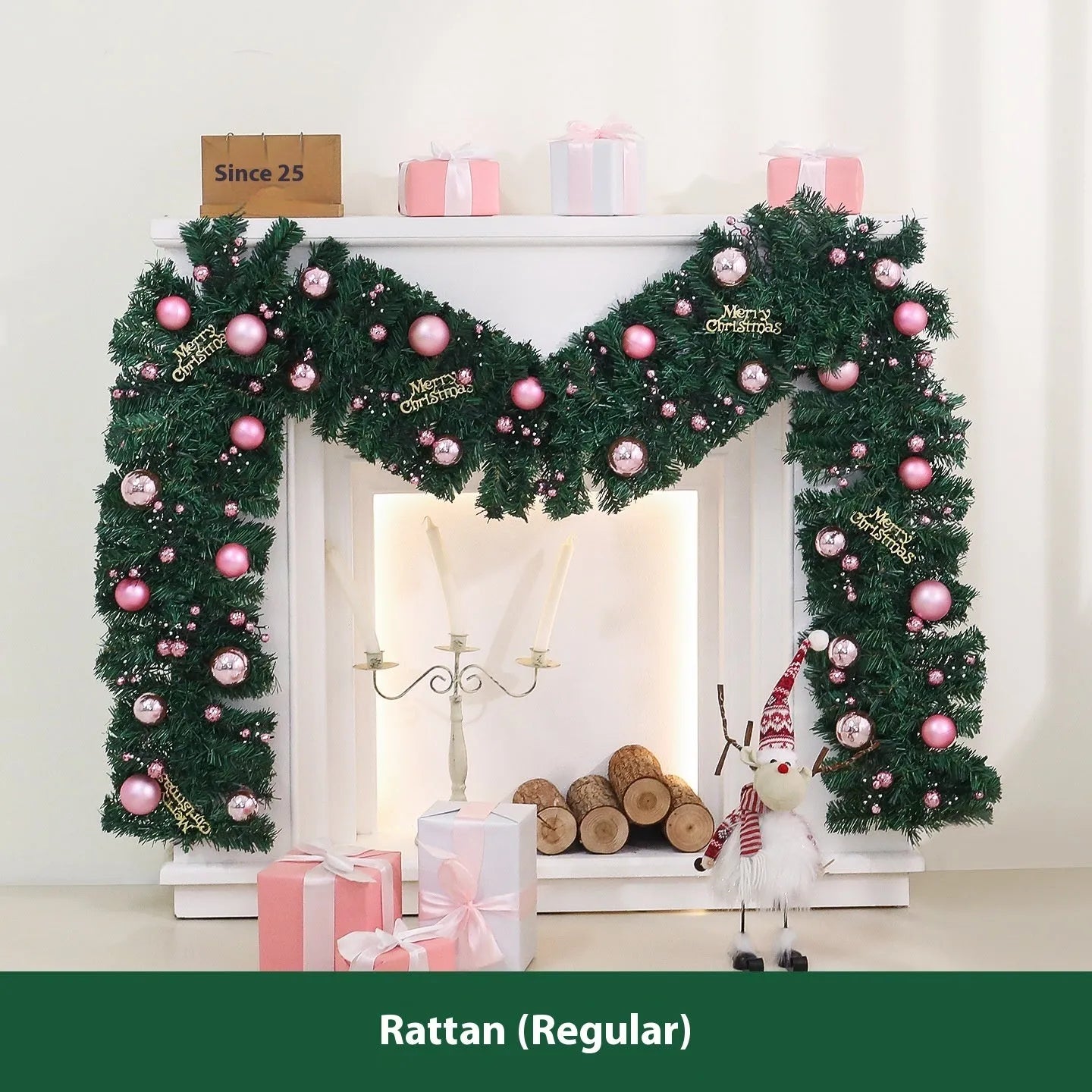 Pink artificial rattan Christmas garland with small fruit and LED lights draped over a banister