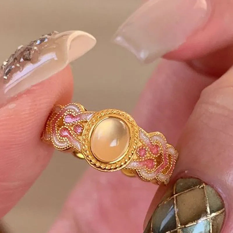 Geometric open ring with pink crystal enamel on gold-plated copper band.
