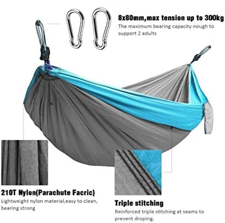 Blue nylon parachute camping hammock hung between two trees, showing its full 270cm length and 140cm width.