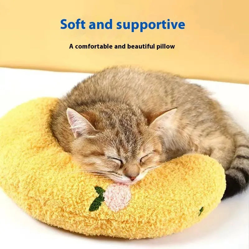 Blue Question Mark shaped cat sleeping mat with integrated U-shaped neck support pillow on a cage floor.