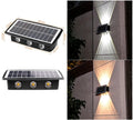 Solar outdoor wall light with 4 LED beads and glass polysilicon panel mounted on a garden wall