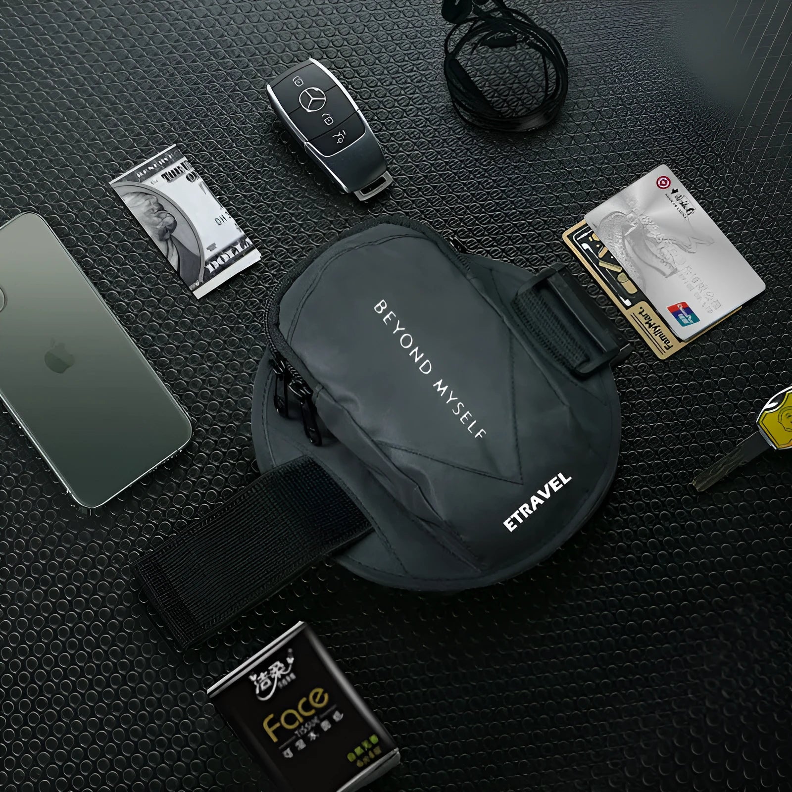 Reflective black running arm bag with adjustable strap, holding a mobile phone, shown on a runner's arm.