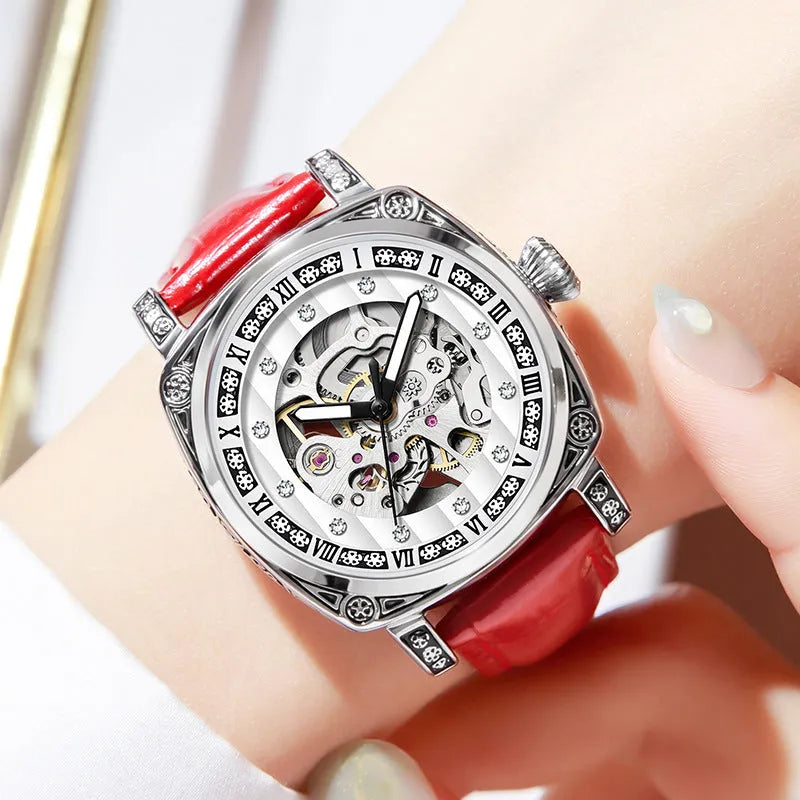Mechanical analogue watch with luminous hands and a leather strap, shown in multiple colour options.