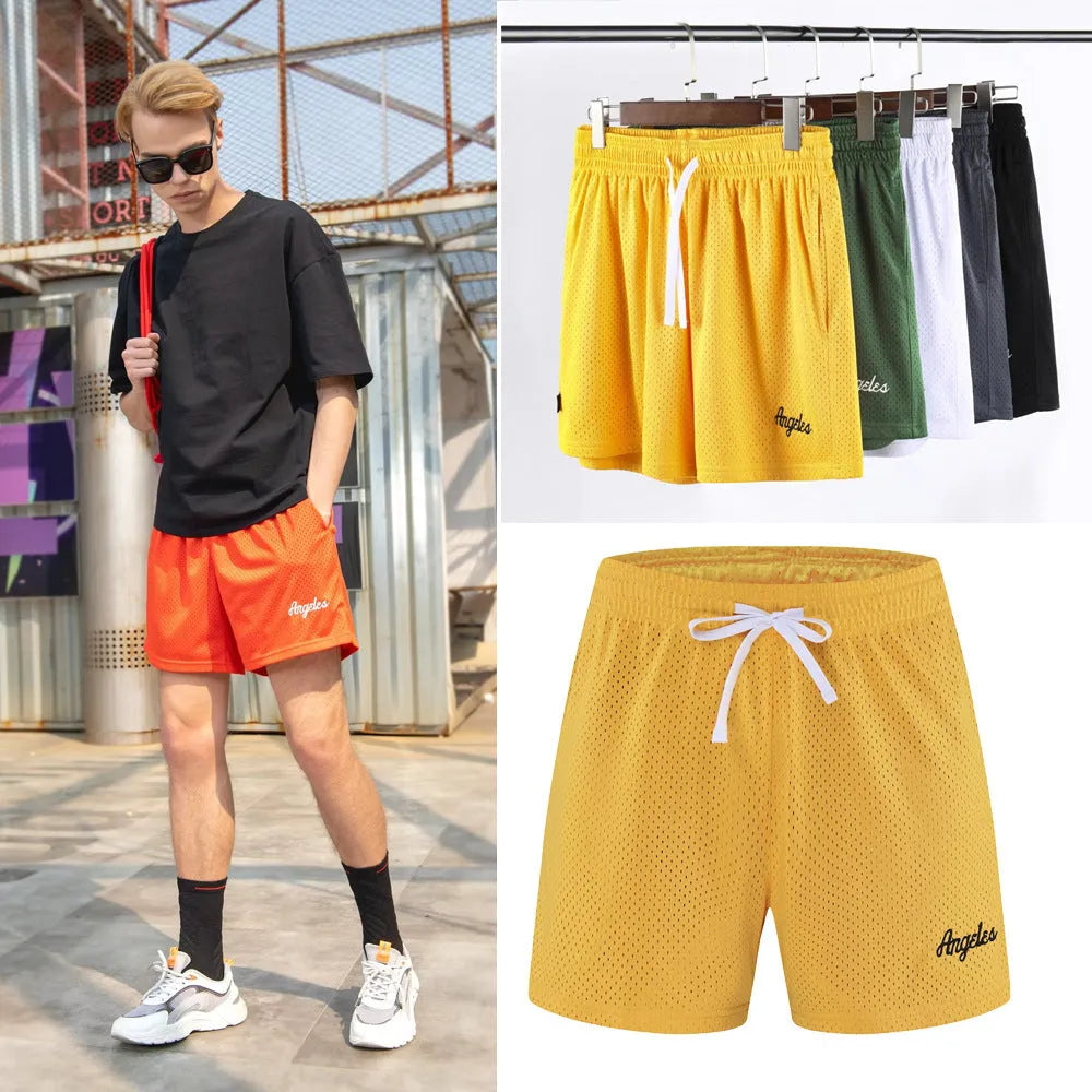 Man wearing black double-layer mesh sports shorts, showing mesh panel detail and short length for running.