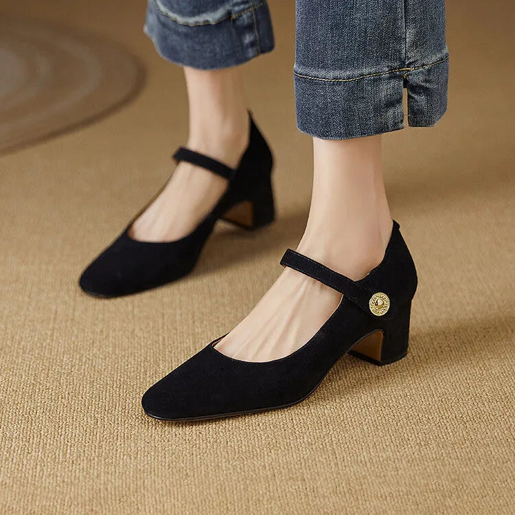 Women's black suede Mary Jane shoes with a square toe and chunky heel on a white background.
