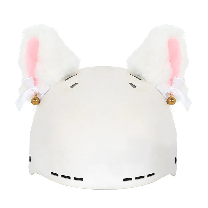 Colourful plush cartoon hat decoration sitting on top of a ski helmet