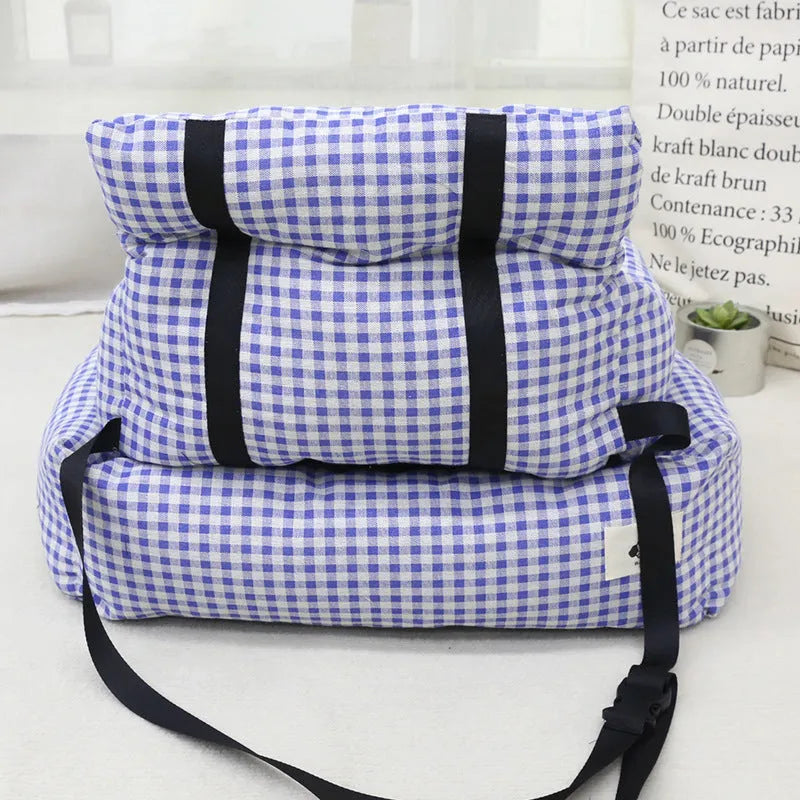 Grey and blue plaid cloth dog nest mounted in a car for pet travel.
