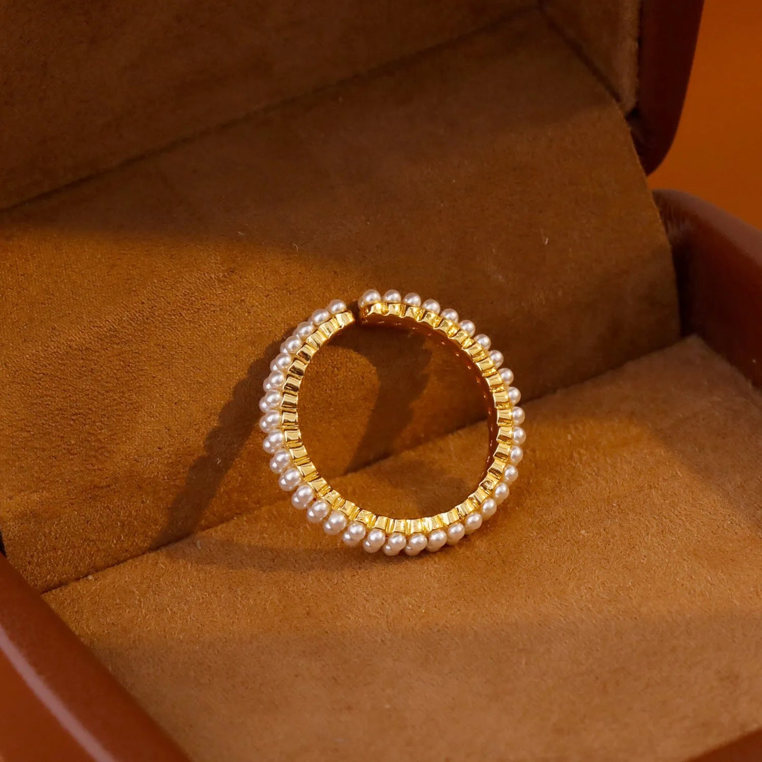 Gold geometric women's ring with open mouth adjustable design and single pearl accent on copper base