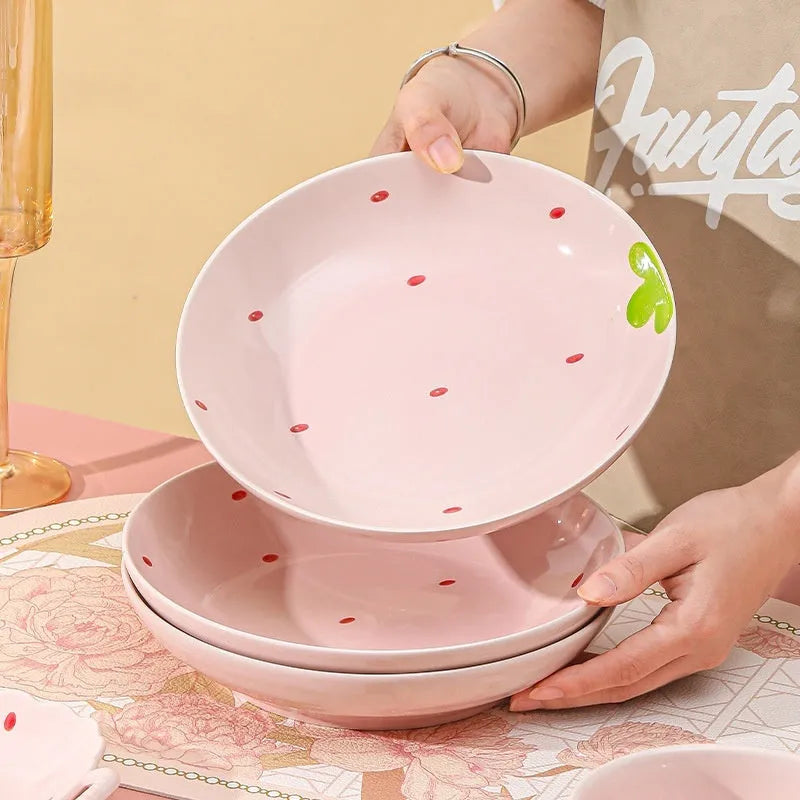 Strawberry-themed porcelain dinnerware set with plates, flower bowls, and microwave-safe spoons