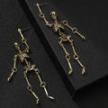 Exaggerated zinc alloy skull earrings in antique silver with line-patterned detailing, unisex design