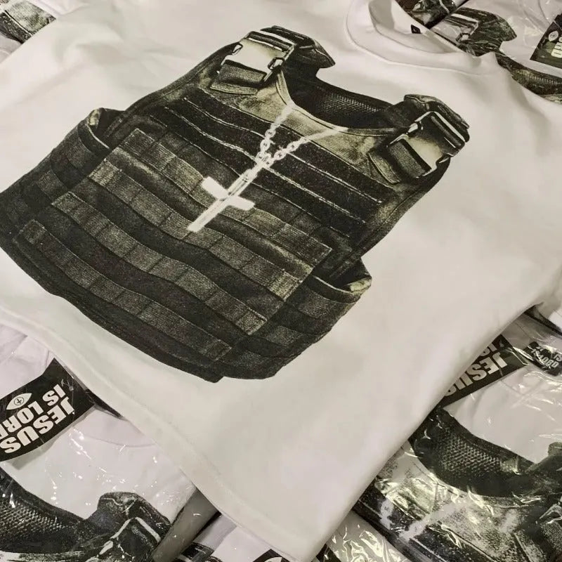 Person wearing a relaxed-fit grey cotton t-shirt with a retro-style graphic print and drop-shoulder sleeves.