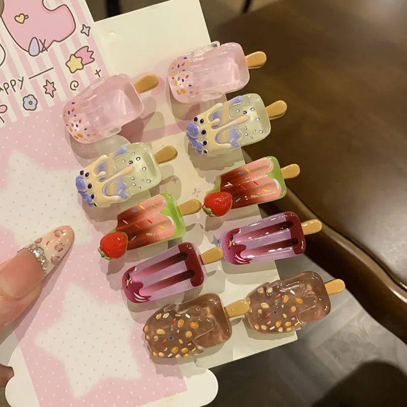 Cartoon ice cream design resin hair barrette clip in side view showing colour options.