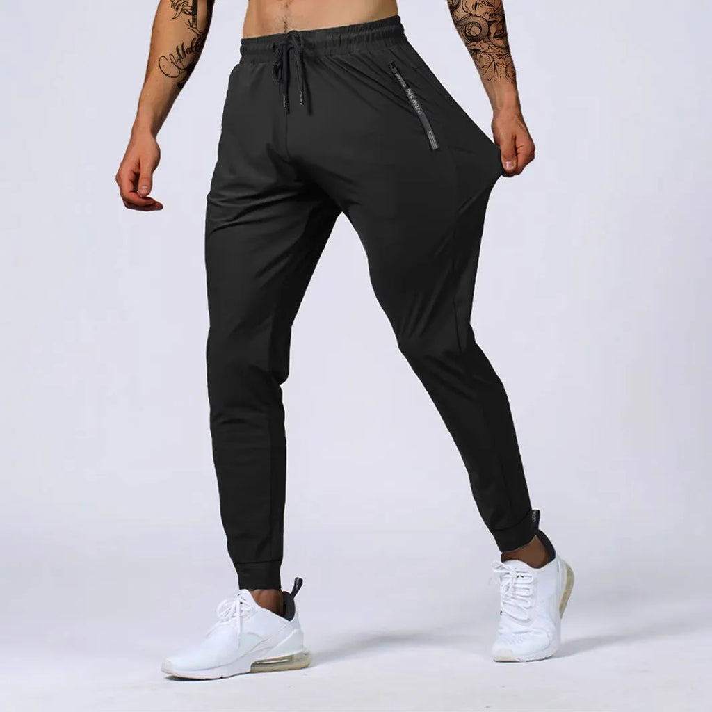 Men's loose mid waist jogging sports pants in black, grey, khaki, or blue, high elasticity nylon blend, sizes L to 7XL
