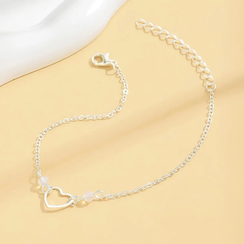 Adjustable alloy anklet with small heart pendant in gold or silver finish