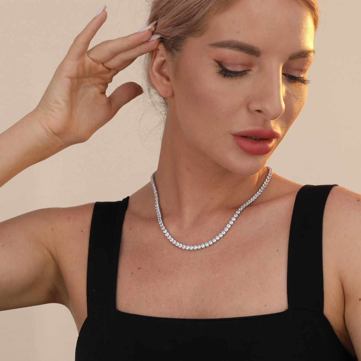 925 sterling silver tennis chain necklace with 4mm cubic zirconia stones and white gold plating on white background