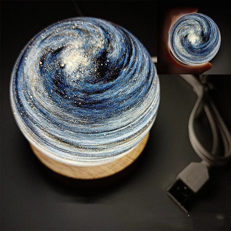 Modern planet-shaped USB night light on its base with dimmable multi-colour glow