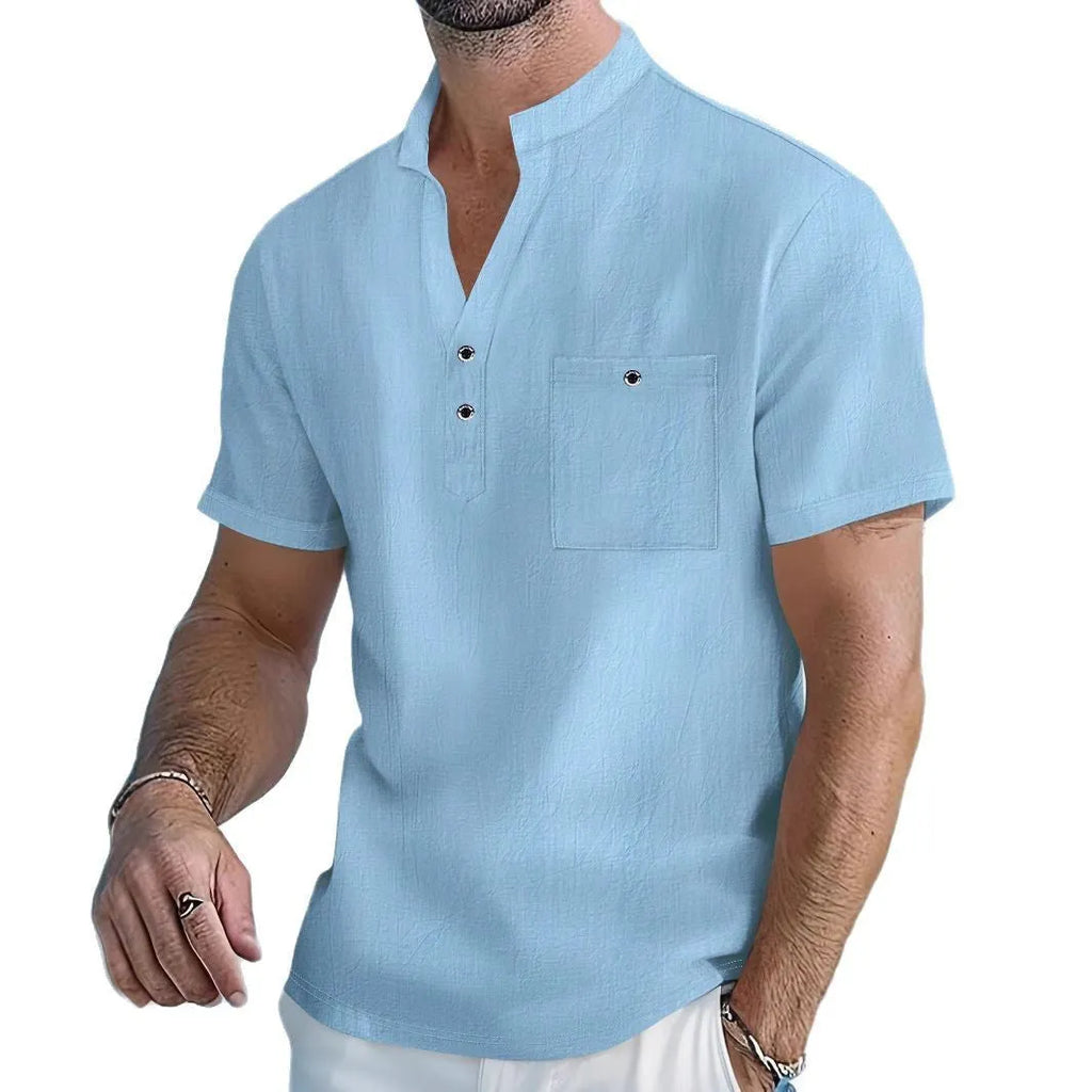 Man wearing a light-coloured linen blend T-shirt with a stand collar and short sleeves.