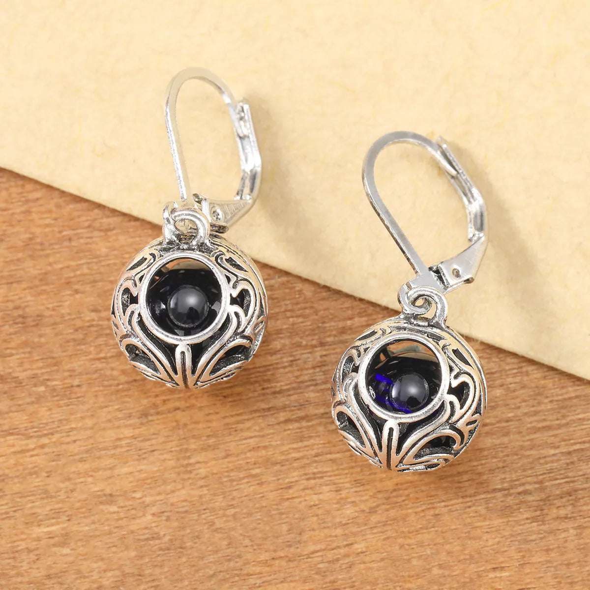 Silver-coloured vintage engraving hollow geometric pendant earrings with blue gemstone