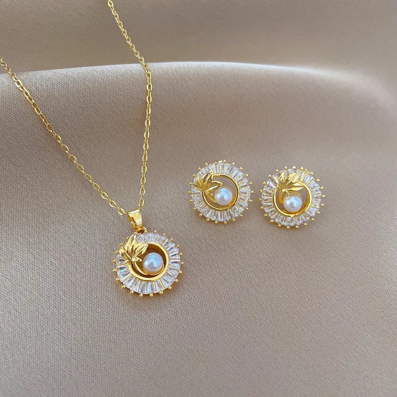 Women's titanium steel necklace and earrings set with square diamond ring pendant and leaf design.