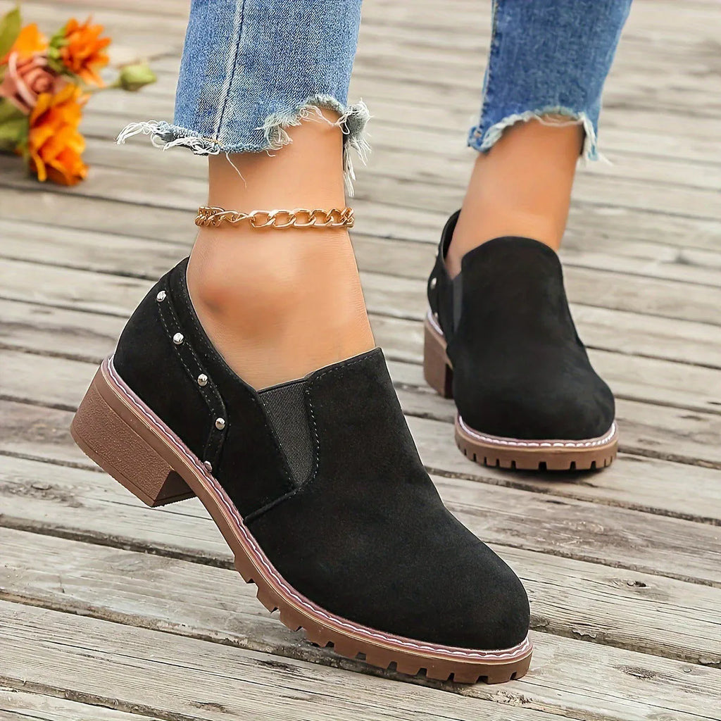 Women's light brown suede ankle boots with a low thick heel and elasticated ankle band.