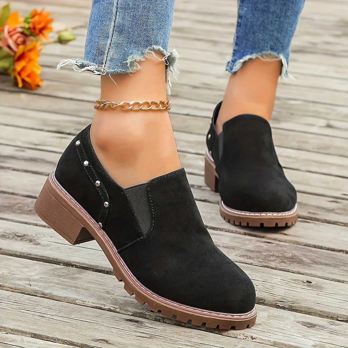 Women's light brown suede ankle boots with a low thick heel and elasticated ankle band.