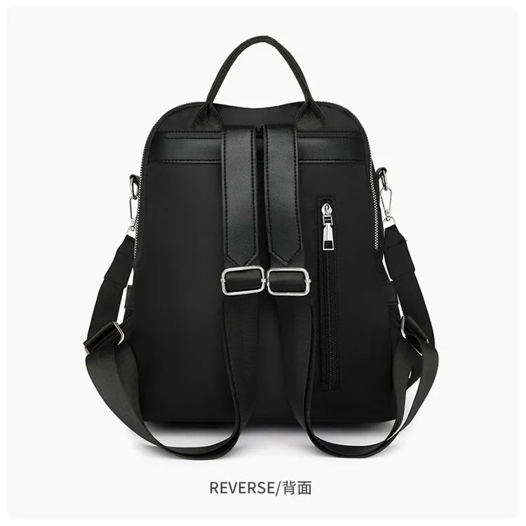 Soft black PU backpack showing three-dimensional front pocket and large main compartment.