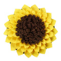Yellow sunflower-shaped dog snuffle mat with fleece surface and a rope for hanging