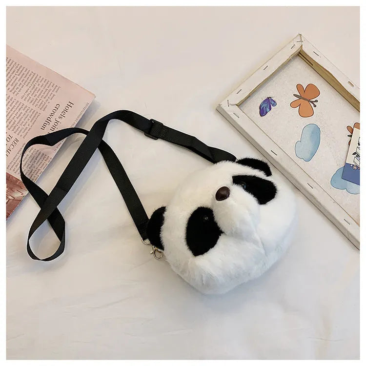 Soft cylindrical plush crossbody bag with panda head design, showing front sandwich pocket.