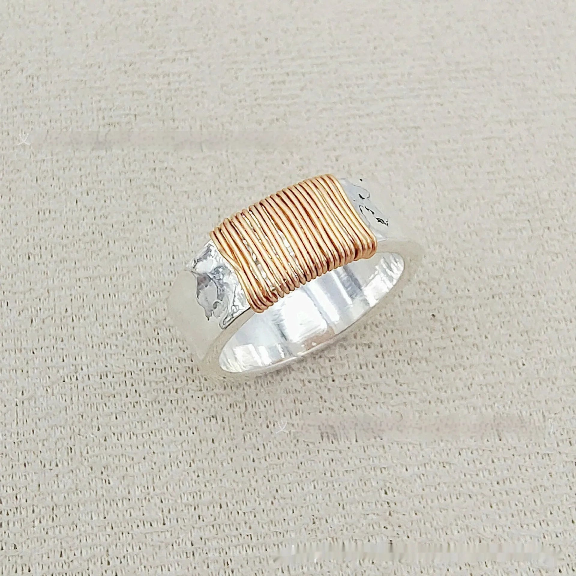 Copper geometric wide ring bracelet with irregular coil design in silver-gold colour.