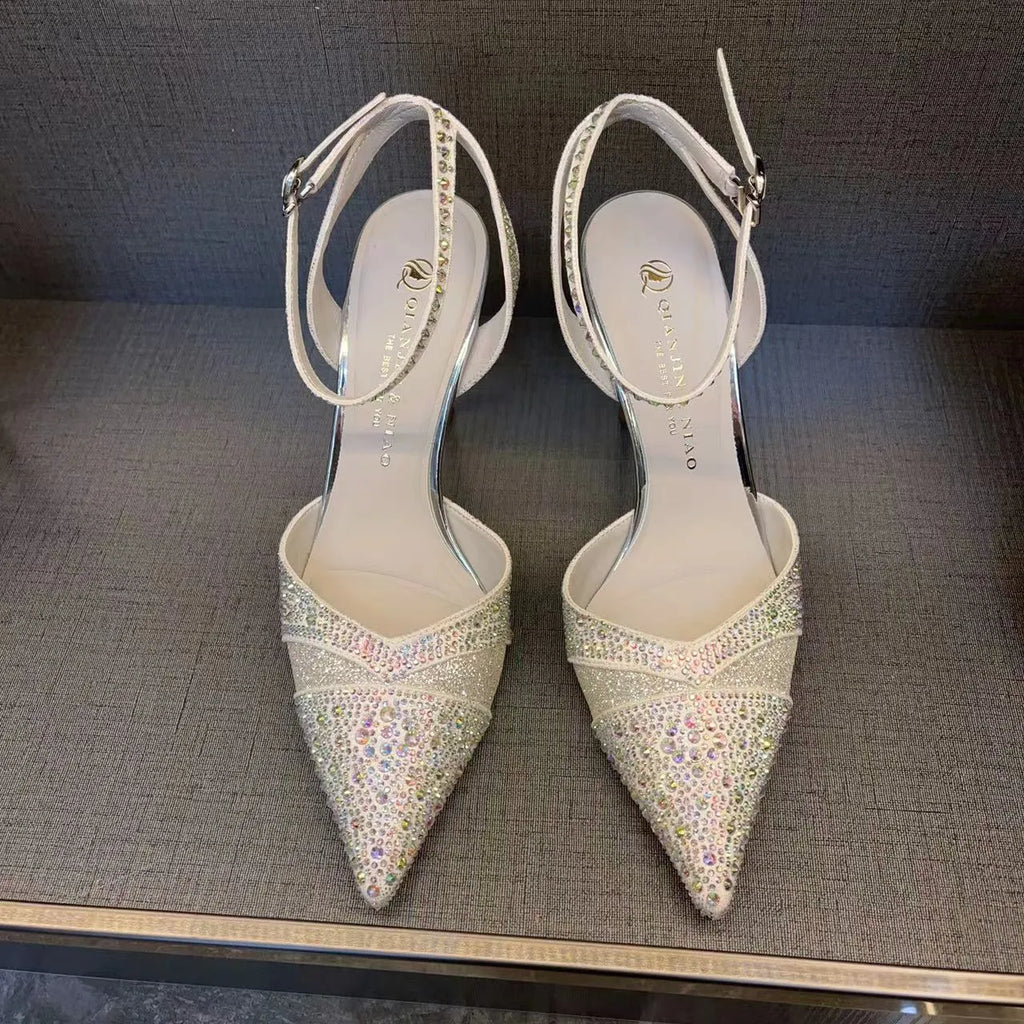 Women's black and silver hollow-cut stiletto heels with a pointed toe and shallow mouth design.
