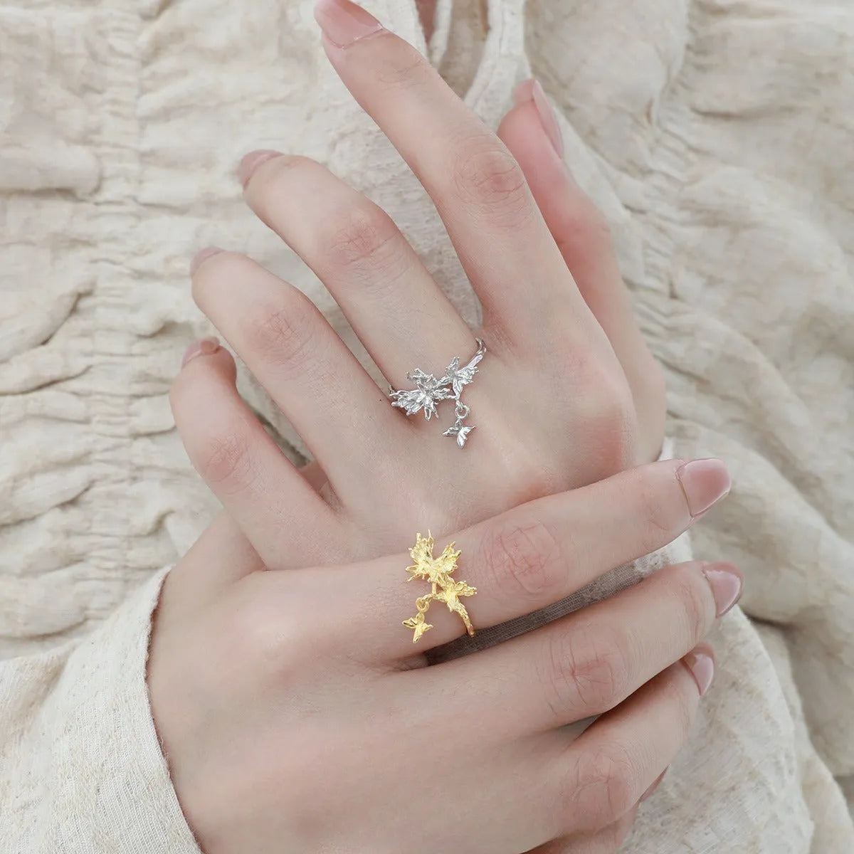 Silver butterfly ring with adjustable opening and electroplated gold finish options.