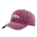 Retro-style personalised embroidered peaked cap with adjustable strap on distressed beige fabric.