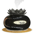 Pure black round Lotus aromatherapy ultrasonic humidifier with USB cable on a desk.