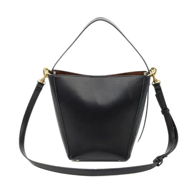 Urban minimalist bucket-style crossbody shoulder bag in PU with three-dimensional outer pocket, black colour option, flat lay view