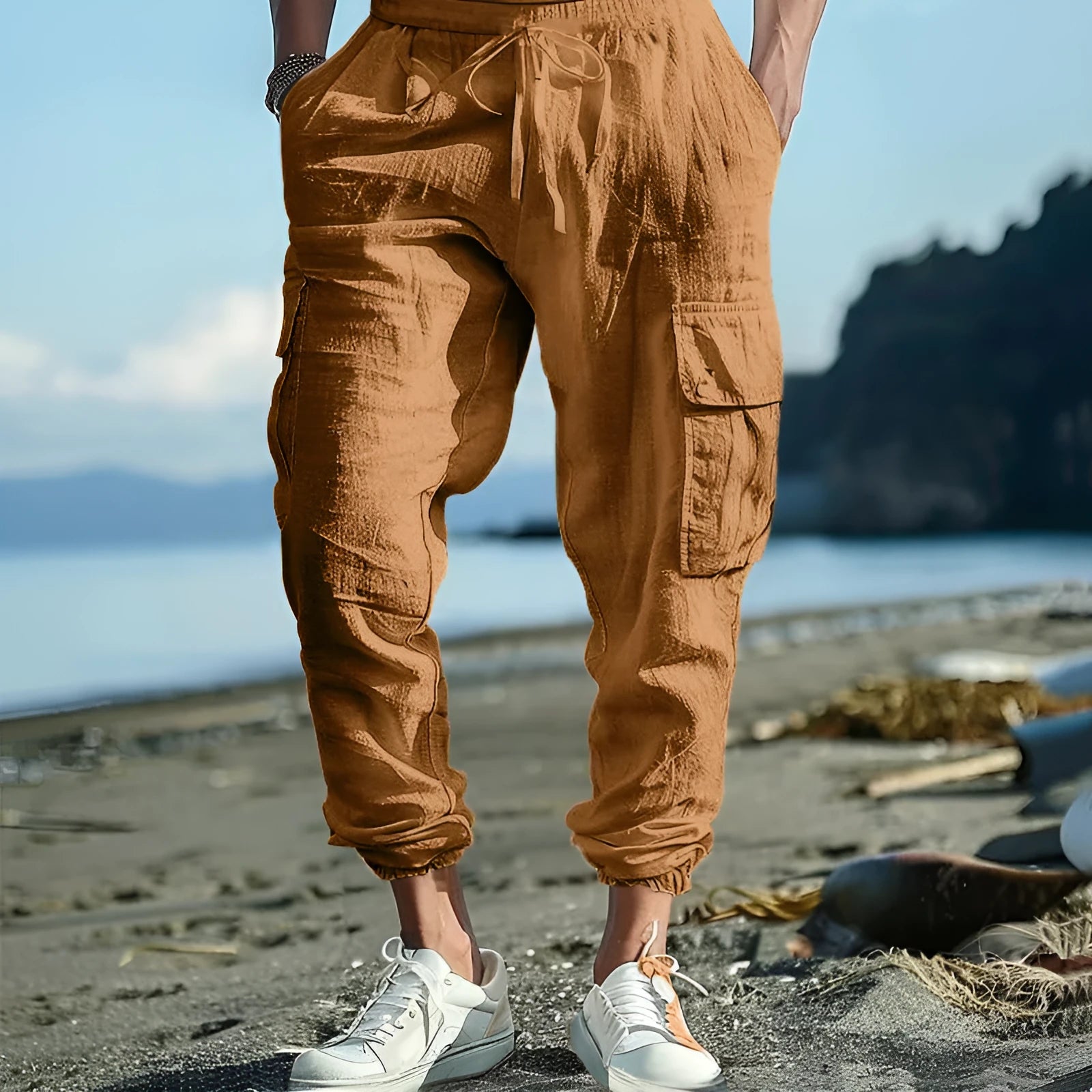 Man wearing khaki linen casual trousers with ankle-tied cuffs and multiple pockets.