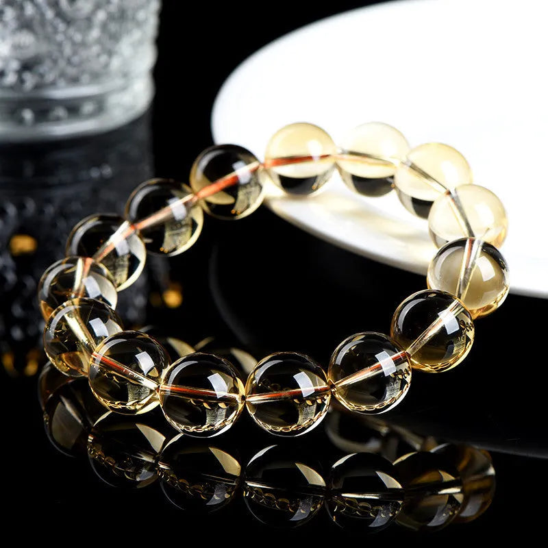Natural golden citrine bead bracelet with scattered design on a wrist, showing adjustable clasp and polished stone detail.