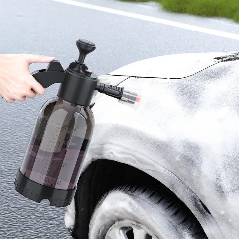 Black handheld 2L foam watering can sprayer with two nozzles and a comfort-grip handle.