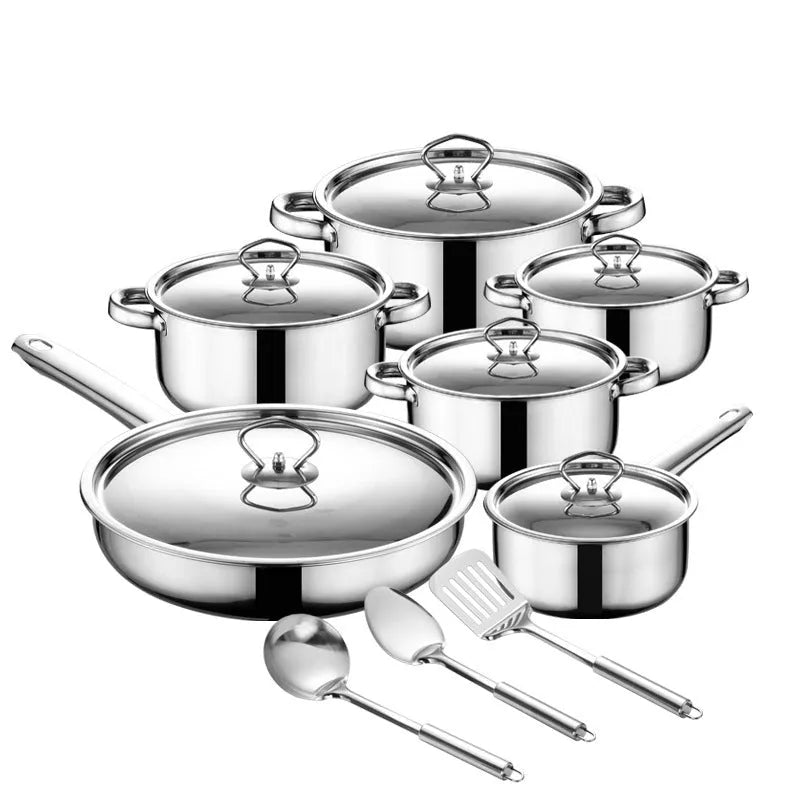 15-piece stainless steel non-stick cookware set with glass lids, spoons, and shovel on a table